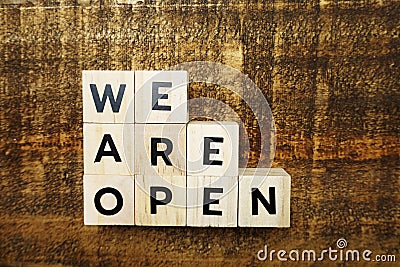 We are open alphabet letters with space copy on wooden background Stock Photo