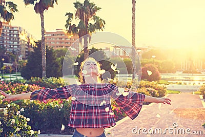 Open arms girl throwing flower petals Stock Photo