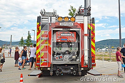 Open back side of red German fire truck with water supply connection Editorial Stock Photo