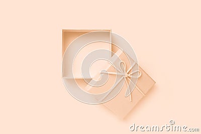 Open beige square gift box with a bow, top view Stock Photo