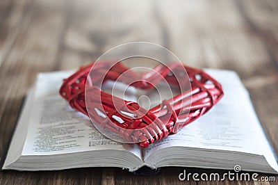 Open bible on the table. A heart. Holy Bible Stock Photo