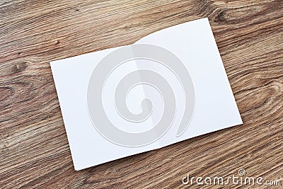 Open blank brochure, magazine is on a wooden desk Stock Photo