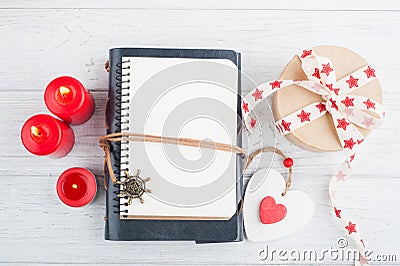 Open blank planner, with lit candles and red heart Stock Photo