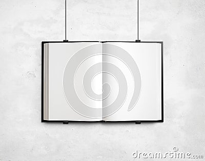 Open blank textbook on white concrete wall Stock Photo