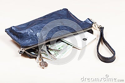 Handbag with phone, keys and euro notes on table Stock Photo