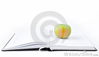 Open book and apple. On a white background. Science and knowledge wisdom concept Stock Photo