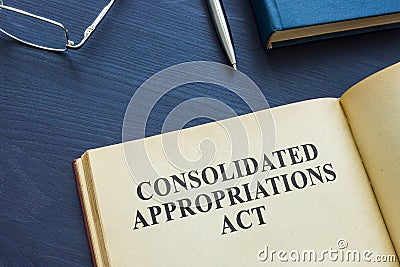Open book with Consolidated Appropriations Act and pen. Stock Photo
