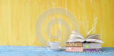 Open book, cup of coffee, panorama format with copy space. Reading, education, literature, learning, book fair concept Stock Photo