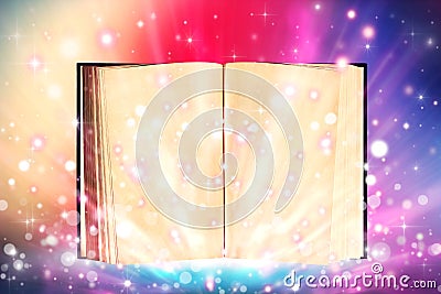 Open book emitting sparkling light Stock Photo