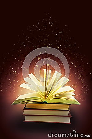 Open book and flying particles and rays, Stock Photo