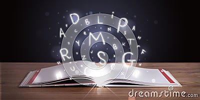 Open book with glowing letters flying Stock Photo