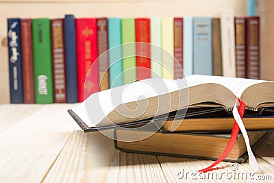 Open book, hardback books on wooden table. Back to Stock Photo