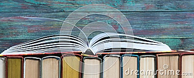 Open book hardback on Stack books Stock Photo