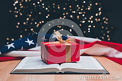 The open book of the Holy Bible. Gift. On the background is a Christmas tree. New Year prayer. Holiday. The birth of Jesus Stock Photo