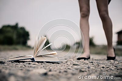 Open book lying on the road. Stock Photo