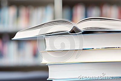 Open book on a stack of books on a table Stock Photo