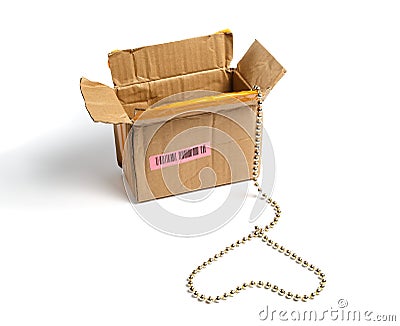 Open cardboard packaging and a gold chain in a heart shape. Stock Photo