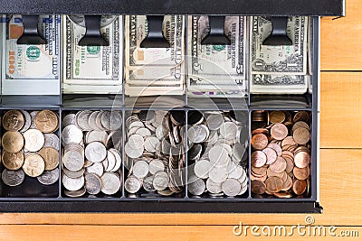 Open cash register drawer on wooden table Stock Photo