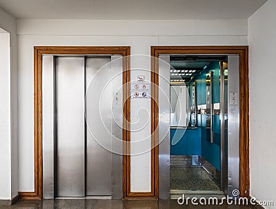 Open and closed chrome metal hotel building elevator doors realistic photo. Stock Photo