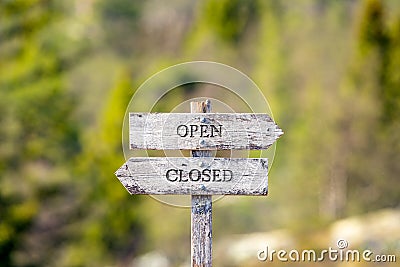 open closed text carved on wooden signpost outdoors in nature Stock Photo