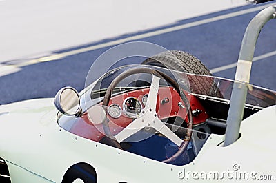 Open cockpit vintage race car with steering wheel and gauges Stock Photo