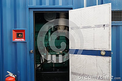 Open door of blue power pack or portable generator for supply of electricity to reefers. Stock Photo