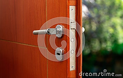 Open door of a family home. Close-up of the lock an armored door. Stock Photo