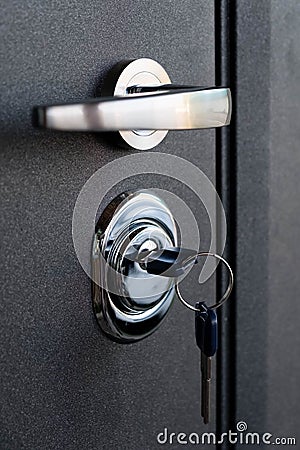 Open door of a family home. Close-up of the lock with your keys on an armored door. Key cylinder, close up photo. door Stock Photo