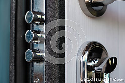 Open door of a family home. Close-up of the lock with your keys on an armored door. Security. Key cylinder, close up Stock Photo