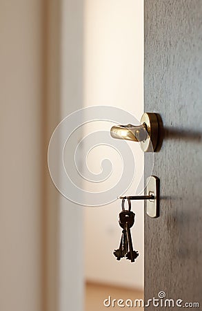 Open door with keys Stock Photo