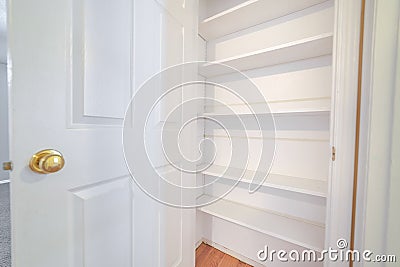 Open door showing interior empty white shelves Stock Photo