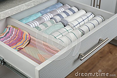 Drawer with folded towels. Order in kitchen Stock Photo