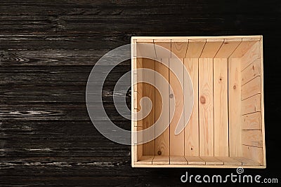 Open empty wooden crate on dark background, top view Stock Photo