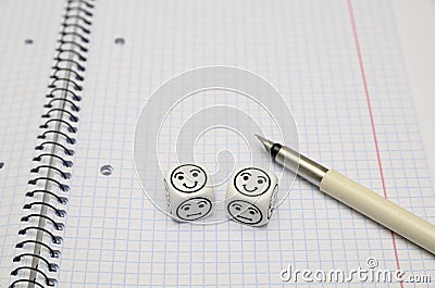 Open exercise book with mood dice (happy) Stock Photo