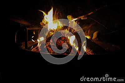 Open fire on campground black background Stock Photo