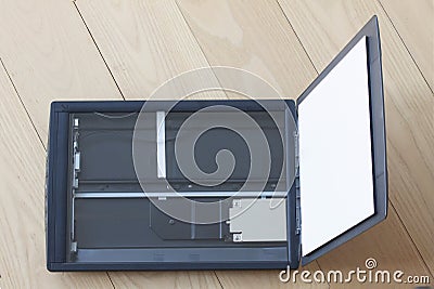 Open flatbed scanner on wooden table. Top view Stock Photo