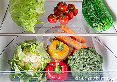 Open fridge filled with fruits and vegetables Stock Photo