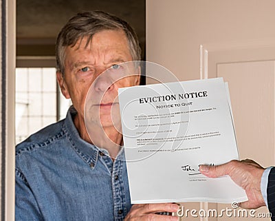 Man in suit giving eviction notice to renter or tenant of home Stock Photo