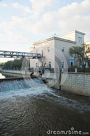 Open gateway on river in summer day Stock Photo