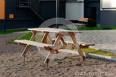 Open gazebo with benches on the lawn with lanterns near the road Stock Photo