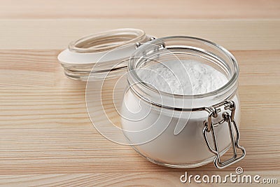 Open glass jar of baking soda Stock Photo