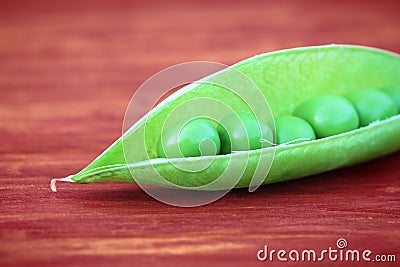 Open green pod of pea Stock Photo