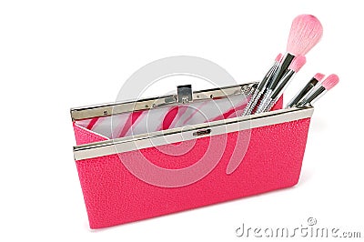 Open handbag with cosmetic brushes Stock Photo