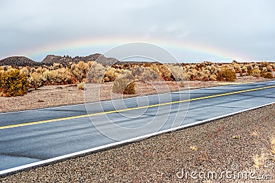 Open highway and rainbow Stock Photo