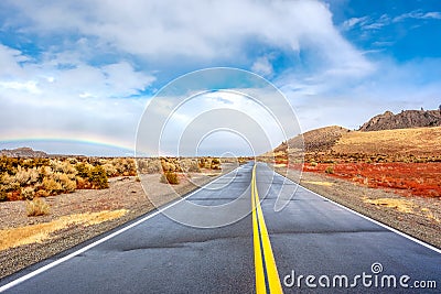 Open highway and rainbow Stock Photo