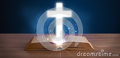 Open holy bible with glowing cross in the middle Stock Photo