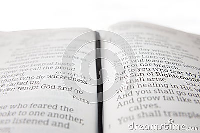 Open holy bible highlighted in Malachi 4:2. Isolated on white background. Selective focus Stock Photo