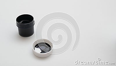 an open jar of black acrylic paint Stock Photo