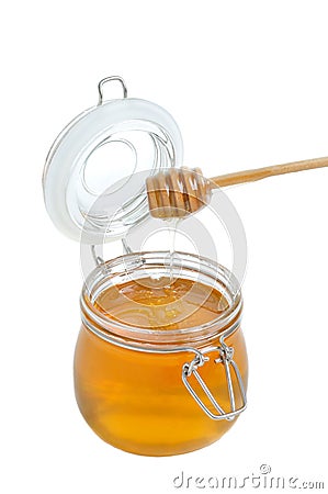Open jar of honey and drizzler on white Stock Photo