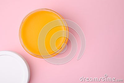 Open jar with petrolatum on pink background, top view. Space for text Stock Photo